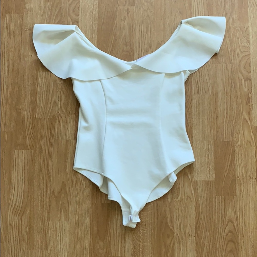 Cream, ruffled double v-neck bodysuit.